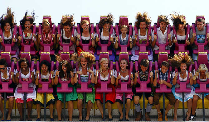 Revellers enjoy a ride in a roller coaster after the opening of the world's biggest beer fest, the Munich Oktoberfest, at the Theresienwiese in Munich, Germany.