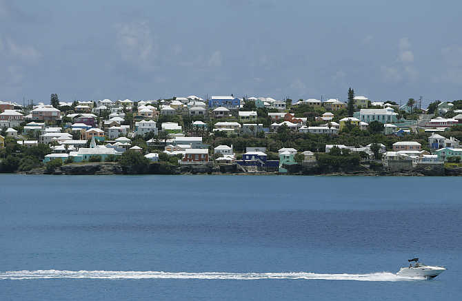 A pleasure power boat parallels the Bermuda coastline near Hamilton in Bermuda.