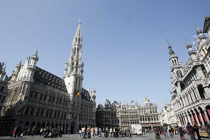Tourists walk on Brussels's famous Grand Place, Belgium.