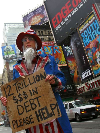 A man dressed as a destitute Uncle Sam begging for $12 trillion demonstrates in New York.