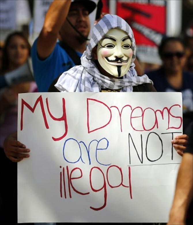 An immigration reform supporter wears a Guy Fawkes mask as he takes part in a May Day demonstation in San Diego.