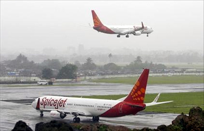 SpiceJet aircrafts prepare for landing and take-off at the airport in Mumbai