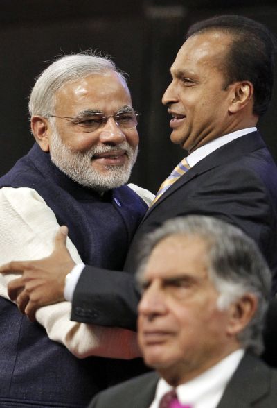 Gujarat's chief minister Narendra Modi (L) and Anil Ambani, chairman of Reliance Group, embrace as Ratan Tata, chairman Emeritus of Tata group, looks on during the inauguration ceremony of the Vibrant Gujarat global investor summit at Gandhinagar in the western Indian state of Gujarat.