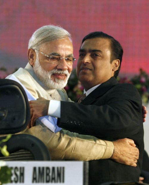 Gujarat's chief minister Narendra Modi (L) embraces Mukesh Ambani, chairman of Indian energy company Reliance Industries, during the Vibrant Gujarat Global Investors' Summit 2011 (VGGIS) at Gandhinagar in the western Indian state of Gujarat.