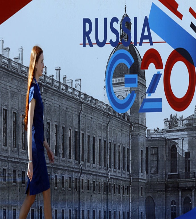 An employee passes by a sign at the main press centre of the G20 summit in Strelna near St. Petersburg.
