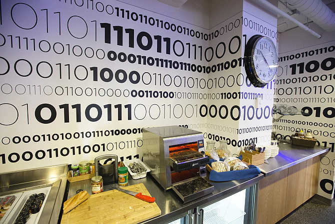 Binary code is written on the wall of the kitchen that displays Google company messages at the Google office in Toronto, Canada.