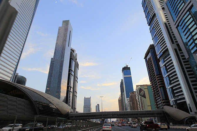 Towers are seen next to a Metro station on Sheikh Zayed Road in Dubai, United Arab Emirates.