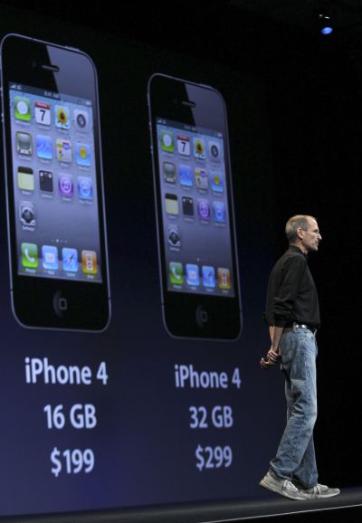 Apple CEO Steve Jobs stands in front of an image of the new iPhone 4 that explains the device's pricing, at the Apple Worldwide Developers Conference in San Francisco, California.