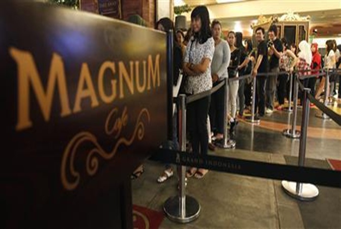 Indonesians queue to taste ice-cream in Magnum cafe in a Jakarta mall.