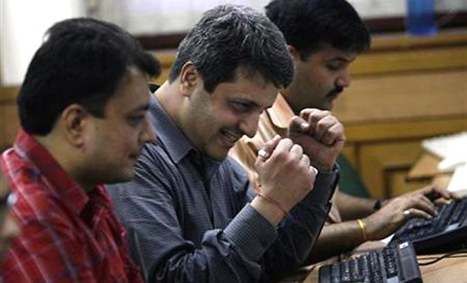 Stock traders in Mumbai react.