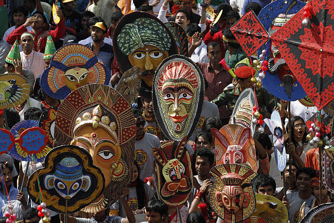 People carry masks during a rally to celebrate Pohela Boishakh, the first day of Bengali new year, in Dhaka, Bangladesh.