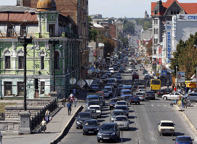 Cars move down a street in central Kharkiv, Ukraine.