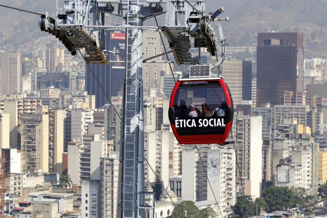 Commuters travel in a Metrocable cabin in Caracas. The Caracas Metrocable cable car starts operations over 1.8 km (0.93 miles) with five stops through the upper slum districts.