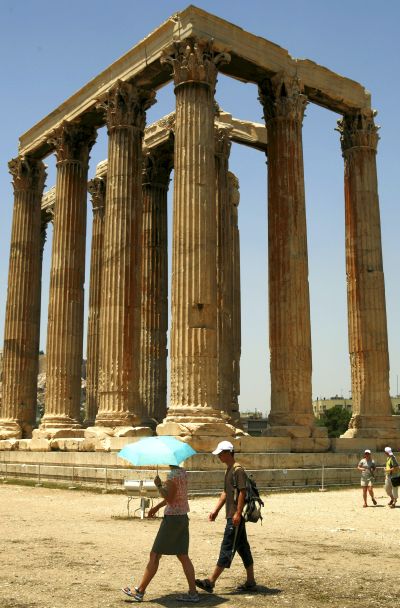 Tourists visit the temple of Olympian Zeus in Athens.