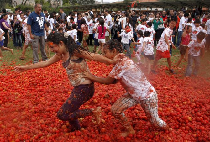 Revellers play with tomato pulp during the annual Tomatina (tomato fight) in Sutamarchan Province in Boyaca.