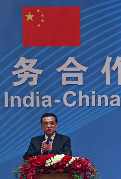 Chinese Premier Li Keqiang gestures as he addresses a gathering during a business summit in Mumbai.
