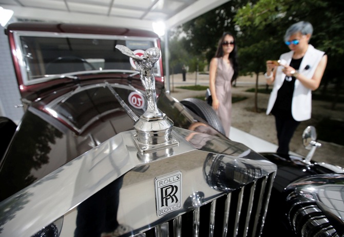 Visitors look around Rolls-Royce's vintage car during the Rolls-Royce's Concours d'Elegance event for celebrating its 10 years of business in China.