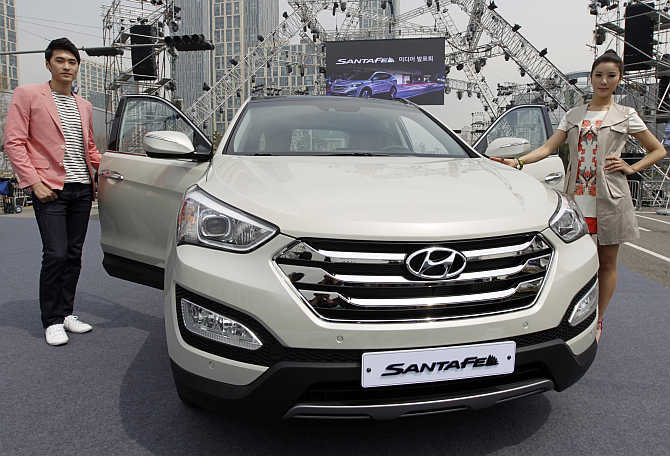 Models pose with Hyundai's Santa Fe in Incheon, west of Seoul, South Korea.