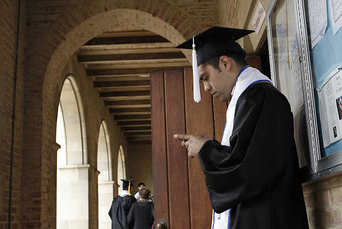 A University of California Los Angeles student checks his mobile phone in Los Angeles, California.