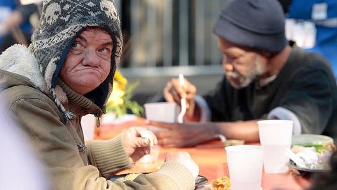 People eat a free Thanksgiving meal at the Los Angeles Mission.