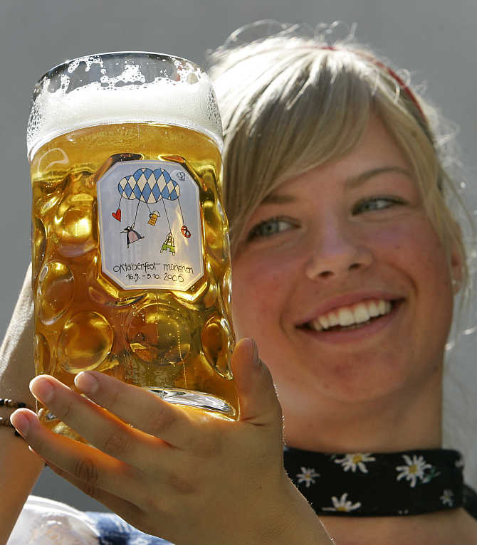 Leonie Stoehr presents Oktoberfest beer mug in Munich, Germany.