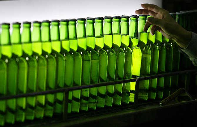 A man picks a bottle at an assembly line inside the Taiwan Beer factory in Jhunan, Miaoli County.