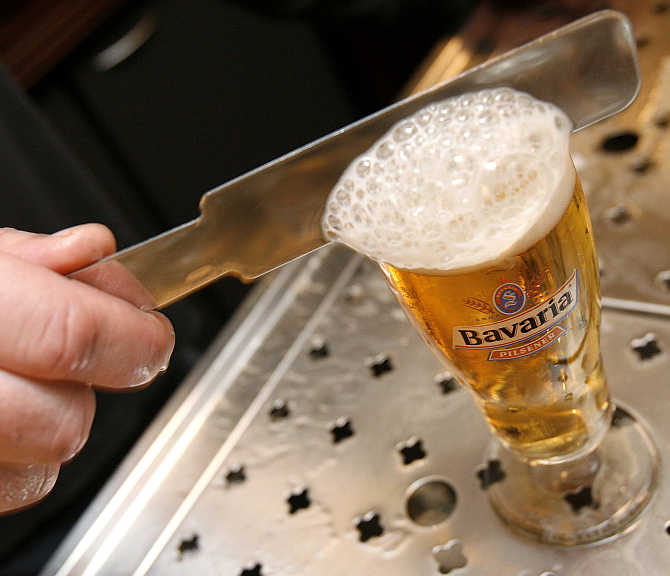 A bartender taps a Bavaria beer at a bar in Haarlem, the Netherlands.