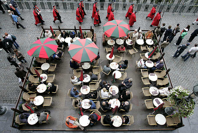 Tourists sit on a terrace during the annual Belgian beer weekend at the Grand Place in Brussels, Belgium.