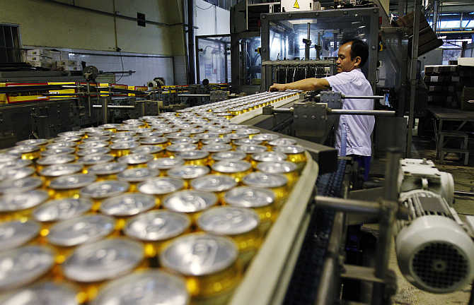 Canned beer move along a production line in Hanoi, Vietnam.