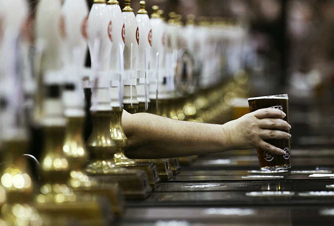 A pint of beer is served through rows of beer pumps at the Campaign For Real Ale Great British Beer Festival at Earls Court in London.