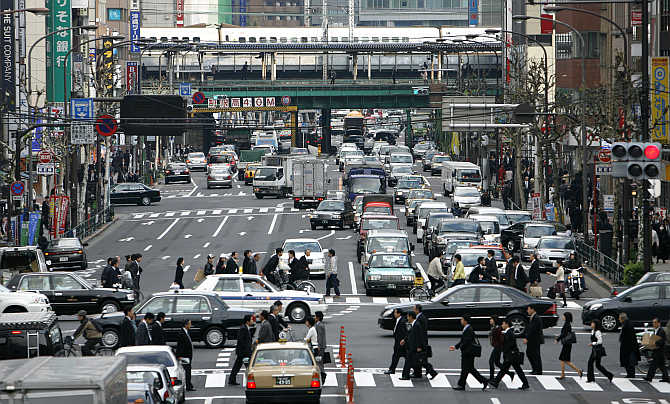 Pedestrians walk across a zebra crossing in Tokyo, Japan.