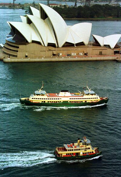 Two ferries pass the Sydney Opera House.