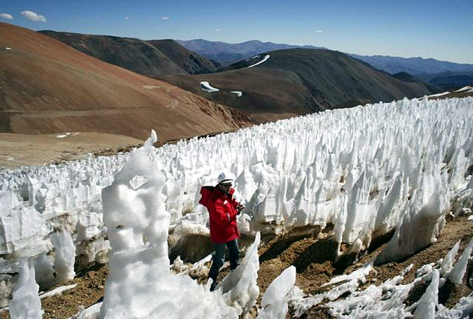 A man walks by the EK Toro II glacier in the on the Chilean side of the border district between Chile's Huasco and Argentina's San Jauan Province.