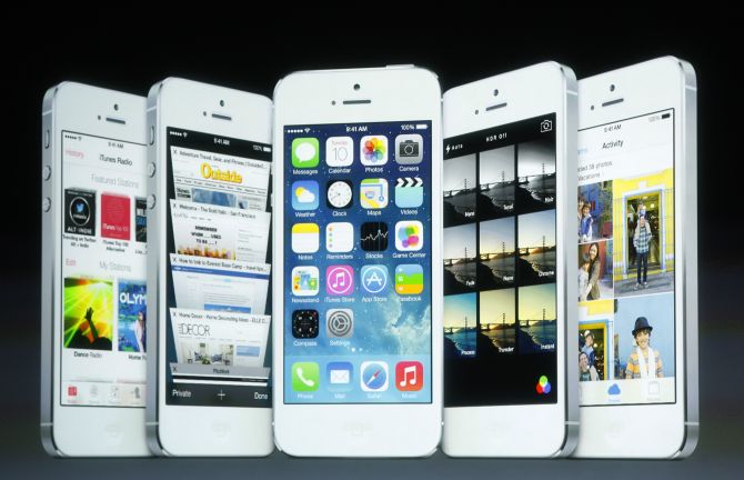 Screenshots of the iOS7 are seen on the screen during Apple Inc's media event in Cupertino, California.