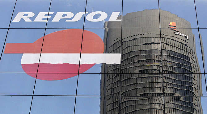 Sacyr Vallehermoso Tower is reflected on the Repsol office building in Madrid, Spain.