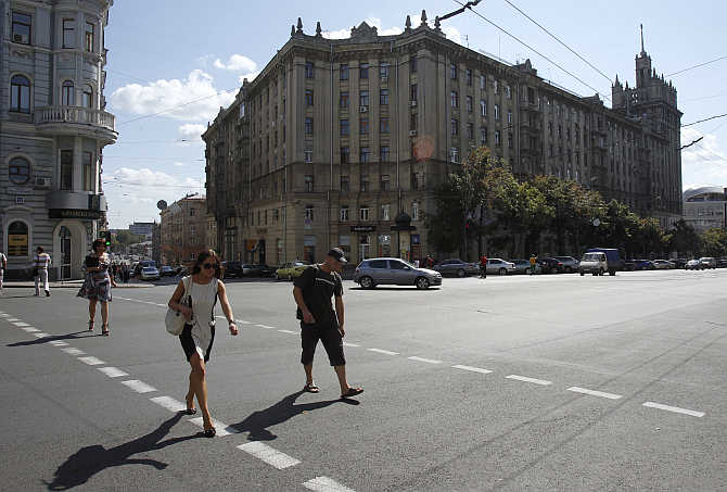 People cross a street in central Kharkiv, Ukraine.