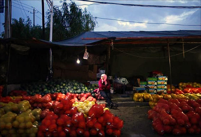 A vendor sits at a local market in Minqin town, Gansu province.