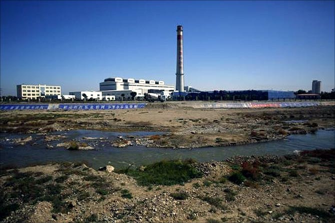 A section of the Shiyang river is seen next to a coal thermoelectric plant in Wuwei, Gansu province.