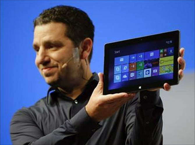 Panos Panay, Microsoft Surface general manager, holds up the Microsoft Surface Pro 2 during the launch of their Surface 2 tablets in New York.