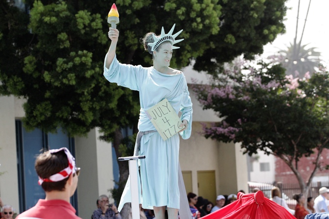 A woman dressed as the Statue of Liberty rides on a float during Santa Monica's seventh annual Fourth of July parade in Santa Monica, California.