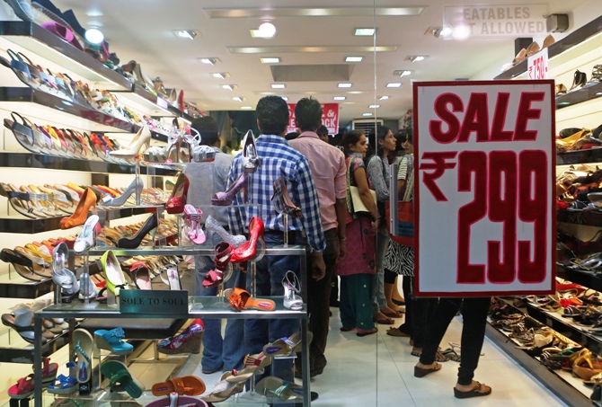 People shop inside a shoe store on a street in Mumbai.