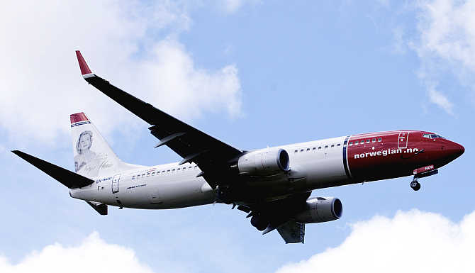 A Norwegian Air plane in the air near Oslo Airport in Norway.