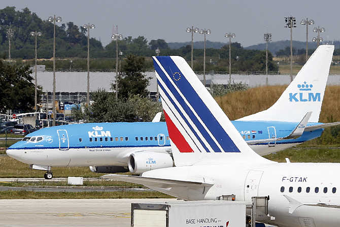 A KLM airline passenger jet rolls behind an Air France plane at the Charles de Gaulle International Airport in Roissy, near Paris, France.
