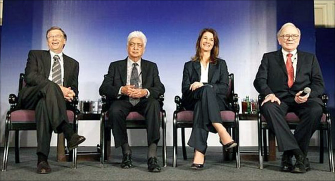 Bill Gates (L) his wife Melinda Gates, Azim Premji (2nd L) and billionaire Warren Buffett (R) attend a news conference.