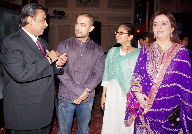 Mukesh Ambani (left), chairman of Reliance Industries, talks with Bollywood actor Aamir Khan and his wife Kiran Rao, as Ambani's wife Nita (right) watches, during the Real Heroes Awards ceremony in Mumbai.