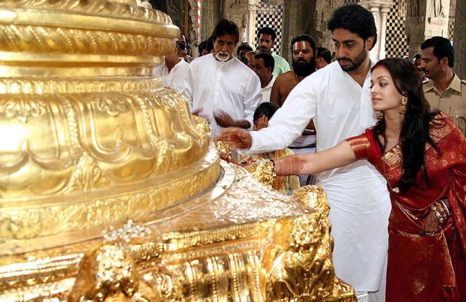 Bollywood star Abhishek Bachchan (3rd R) and his wife, actress Aishwarya Rai (2nd R), perform prayers at Tirumala Tirupati Devasthanam temple shrine in Tirumala.