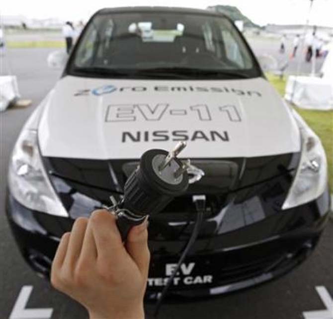 A 100 volt AC power cable is displayed in front of Nissan Motor Co's new electric vehicle.
