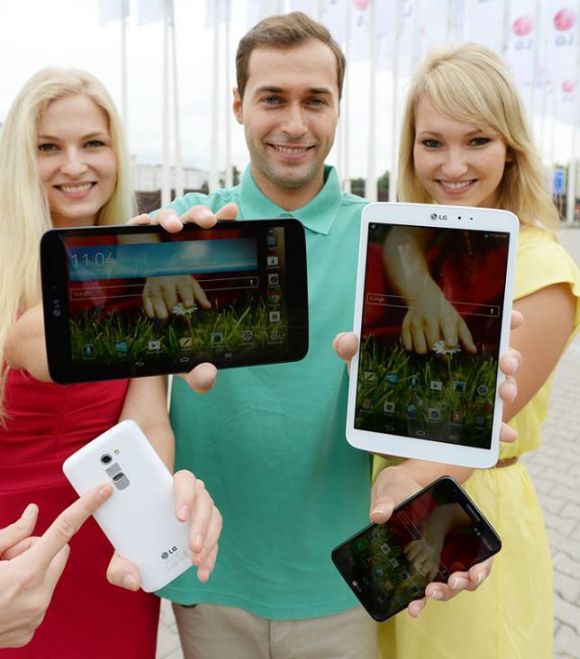 Models hold various LG smartphones.