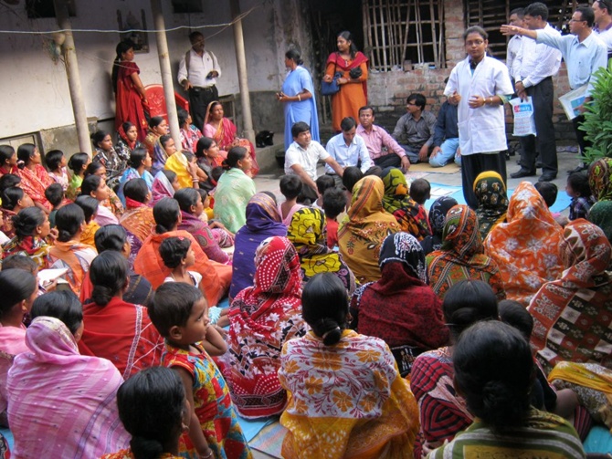 Bandhan employees talk to rural people.