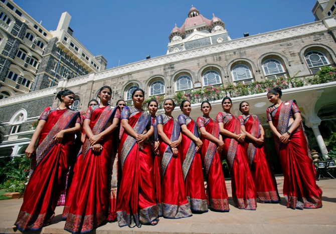 Staff of the Taj Mahal Palace hotel pose for a photo during a photo call in Mumbai.